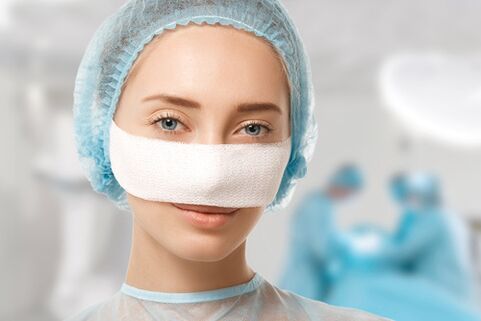 During rehabilitation after rhinoplasty, a bandage is attached to the nose